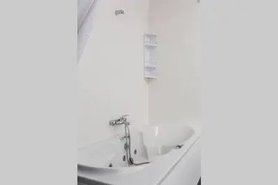 a sink in a bathroom with a white wall at REMODELED APARTMENT IN THE CITY CENTER. (FARO) in Faro