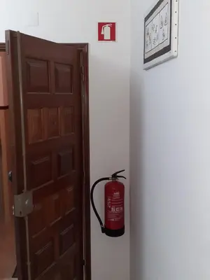 a fire hydrant is sitting next to a door at OCEAN VIEW Quartos in Faro