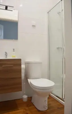 a bathroom with a toilet and a glass shower at Baron Faro - Guest House in Faro