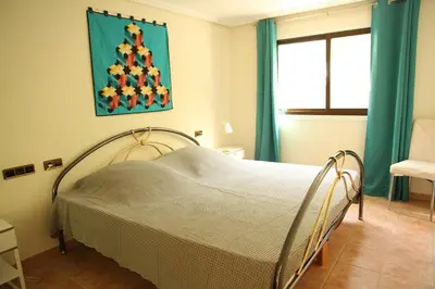 a living room with a sliding glass door to a balcony at O Pinheiro - Apartment Hannah in Olhos de Água