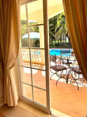 a sliding glass door leading to a patio with a pool at Magellan House in Vilamoura