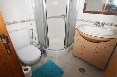 a bathroom with a toilet and a shower and a sink at Waves Studio - Albufeira in Albufeira