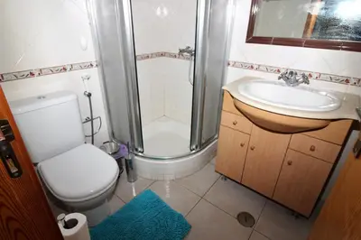 a bathroom with a shower and a toilet and a sink at Waves Studio - Albufeira in Albufeira
