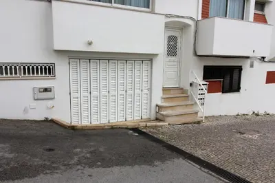 a white house with a door and stairs at Waves Studio - Albufeira in Albufeira