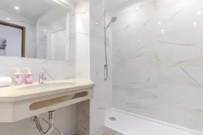 a bathroom with a sink and a tub and a mirror at #015 Buganvilia by Home Holidays in Albufeira