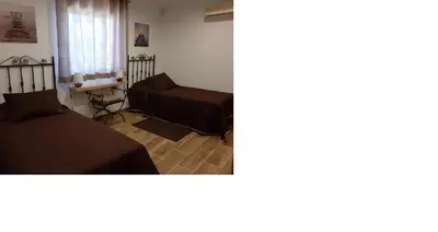 a living room with a bed and a couch at Quinta Vita - Vila Pera in Almancil