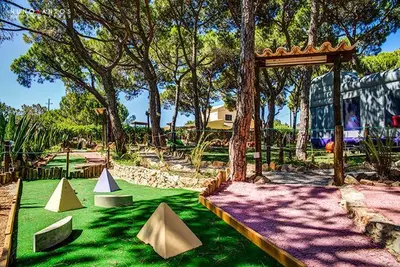 a park with a playground with pretend play tents at Quinta Vita - Vila Pera in Almancil