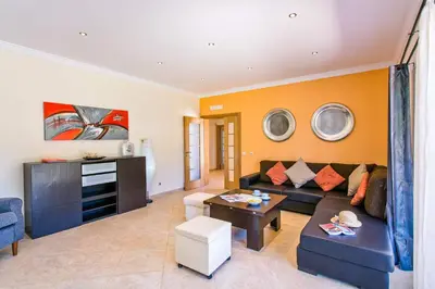 a living room with a couch and a table at Villa Nincha - Heated Pool - Free wi-fi - Air Con in Albufeira