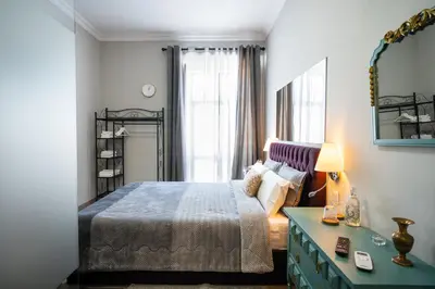 a bedroom with a bed and a table and a mirror at Downtown Loulé in Loulé