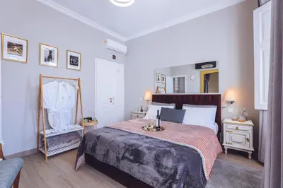 a bedroom with a large bed and a chair at Downtown Loulé in Loulé