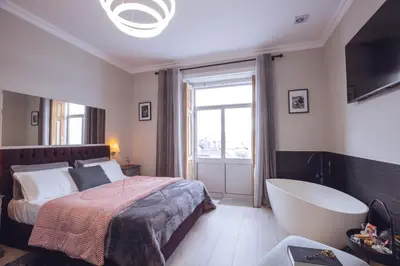 a bedroom with a bed and a bath tub at Downtown Loulé in Loulé