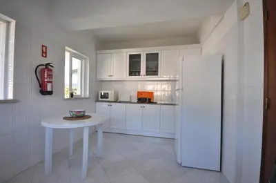 a house with a blue sheet on the porch at Charming Villa, Private Pool, Walking Distance to Centre, Free AC Wifi in Quarteira