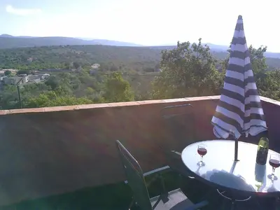 a table with a flag and two glasses of wine at Casa Do Forno - Quinta Amoreira in Faro