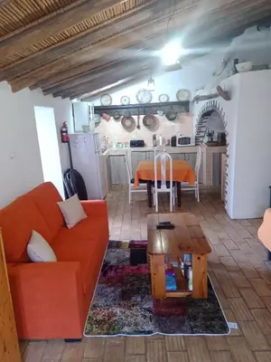 a living room with a couch and a table at Casa Do Forno - Quinta Amoreira in Faro