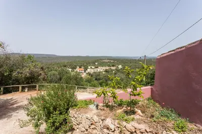 a view of a hill with a house in the distance at Casa Do Forno - Quinta Amoreira in Faro