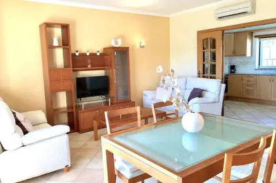 a living room with a table and some chairs at Albufeira edificio Marina Inn Pateo in Albufeira