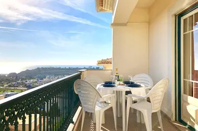 a white table and chairs on a balcony with a view at Albufeira edificio Marina Inn Pateo in Albufeira