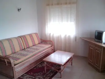 a living room with a couch and a coffee table at Albufeira 1 bedroom apartment 5 min from Falesia beach and close to center L in Albufeira