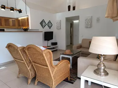 a living room with wicker chairs and a couch at Villa 81 great spot Oura beach, Albufeira in Albufeira