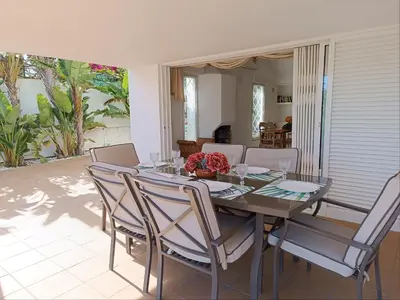 a dining room with a table and chairs at Villa 81 great spot Oura beach, Albufeira in Albufeira
