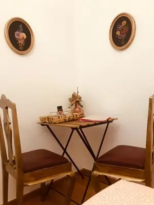 a table with two chairs and two plates on the wall at The Portuguese Element in Faro