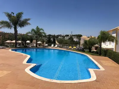 a large blue swimming pool in a resort at Villa Adrian & Brian in Albufeira