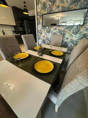 a dining table with yellow plates on top of it at Villa Quévin in Albufeira