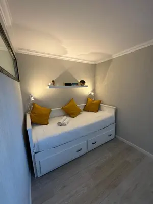 a bedroom with a bed with yellow pillows on it at Villa Quévin in Albufeira