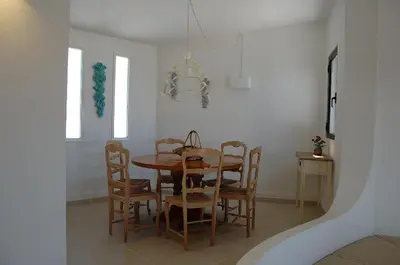 a dining room with a wooden table and chairs at Villa 2, great spot Oura beach, Albufeira in Albufeira