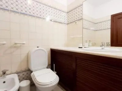 a bathroom with a toilet and a sink at Areias Apartment by Stay ici Algarve Holiday Rental in Albufeira