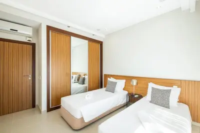 a hotel room with two beds and a mirror at Villa Orada in Albufeira
