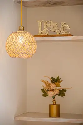 a pendant light and a vase with flowers on a shelf at All Dreams Apartment - Urbanização Windmill in Albufeira