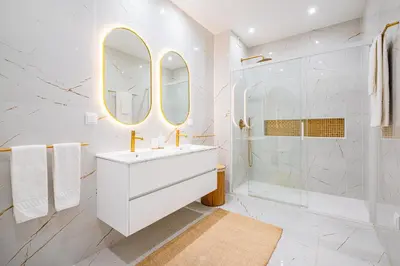 a white bathroom with a sink and a shower at All Dreams Apartment - Urbanização Windmill in Albufeira