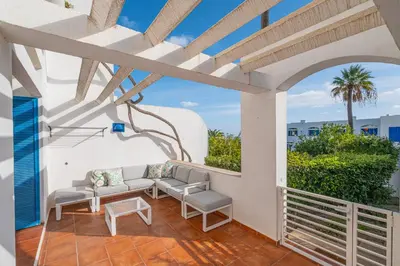 a patio with chairs and a table on a balcony at All Dreams Apartment - Urbanização Windmill in Albufeira