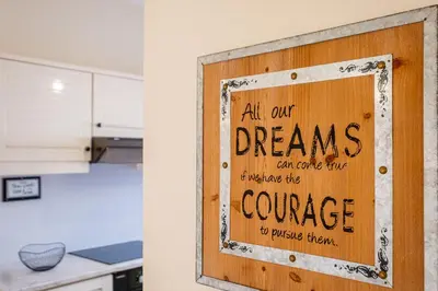 a sign that reads all our dreams can come true unless the courage to pursue them at All Dreams Apartment - Urbanização Windmill in Albufeira