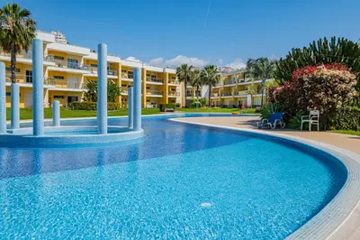 a swimming pool in front of a resort at Marina Garden Apartment in Albufeira