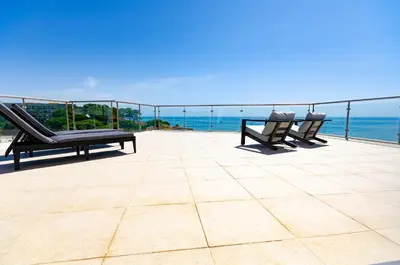 two chairs sitting on a patio overlooking the ocean at Penthouse Apartment, Superb sea view 1 Bedroom, Verandas do Mar AT02 in Albufeira
