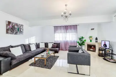a living room with a couch and a table at Villa Machado in Albufeira