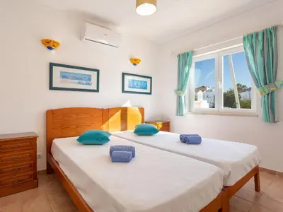 a bedroom with two beds with blue pillows and a window at Villa Villa Blue Ocean by Interhome in Patroves
