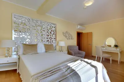 a bedroom with a bed and a desk and a mirror at Marina Ocean Residence in Albufeira