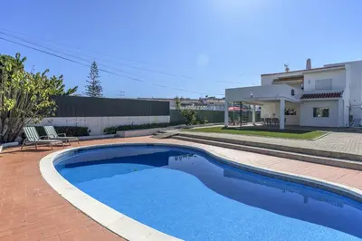 a swimming pool in a yard with a house at FLH Albufeira Vila Mira Flat with Pool in Albufeira