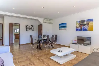a living room with a white couch and a table at FLH Albufeira Vila Mira Flat with Pool in Albufeira