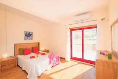a bedroom with a bed and a large window at Villa Acapulco by Algarve Vacation in Albufeira