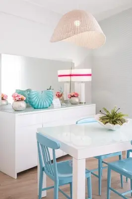 a dining room with a white table and blue chairs at Marina Design T1 in Albufeira