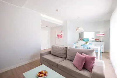 a living room with a couch and a table at Marina Design T1 in Albufeira
