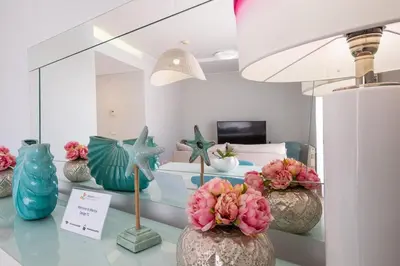 a room with a bed and some vases with flowers at Marina Design T1 in Albufeira
