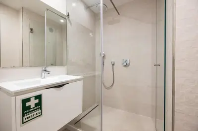 a bathroom with a shower and a sink at Marina Design T1 in Albufeira