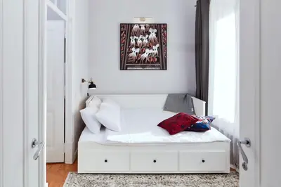 a white bed in a room with a picture on the wall at Pereiras House of Charm - Downtown in Faro