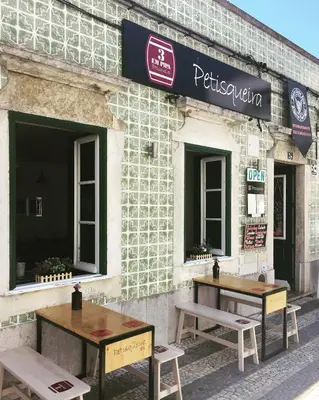 two tables in front of a building with windows at Pereiras House of Charm - Downtown in Faro