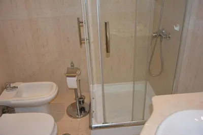 a bathroom with a shower and a toilet and a sink at Paradise Beach Villa in Albufeira